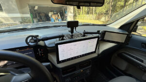 “Clean ham radio control head and phone mounted on a dash grid in a truck—DIY install under an hour.”