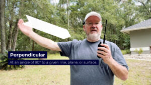 Operator shows how to hold a VHF handheld radio perpendicular to the ISS antenna to copy SSTV with a stock antenna—no special gear needed.