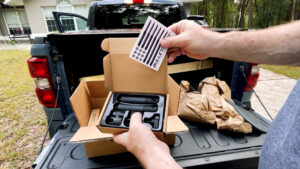 “Unboxing Bulletpoint Mounting Solutions carbon-fiber mounting arm kit on a truck tailgate—arm, clamps, and hardware shown.”