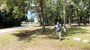 Professor Jim walks across the yard while laying out wire for the first antenna at the new QTH.